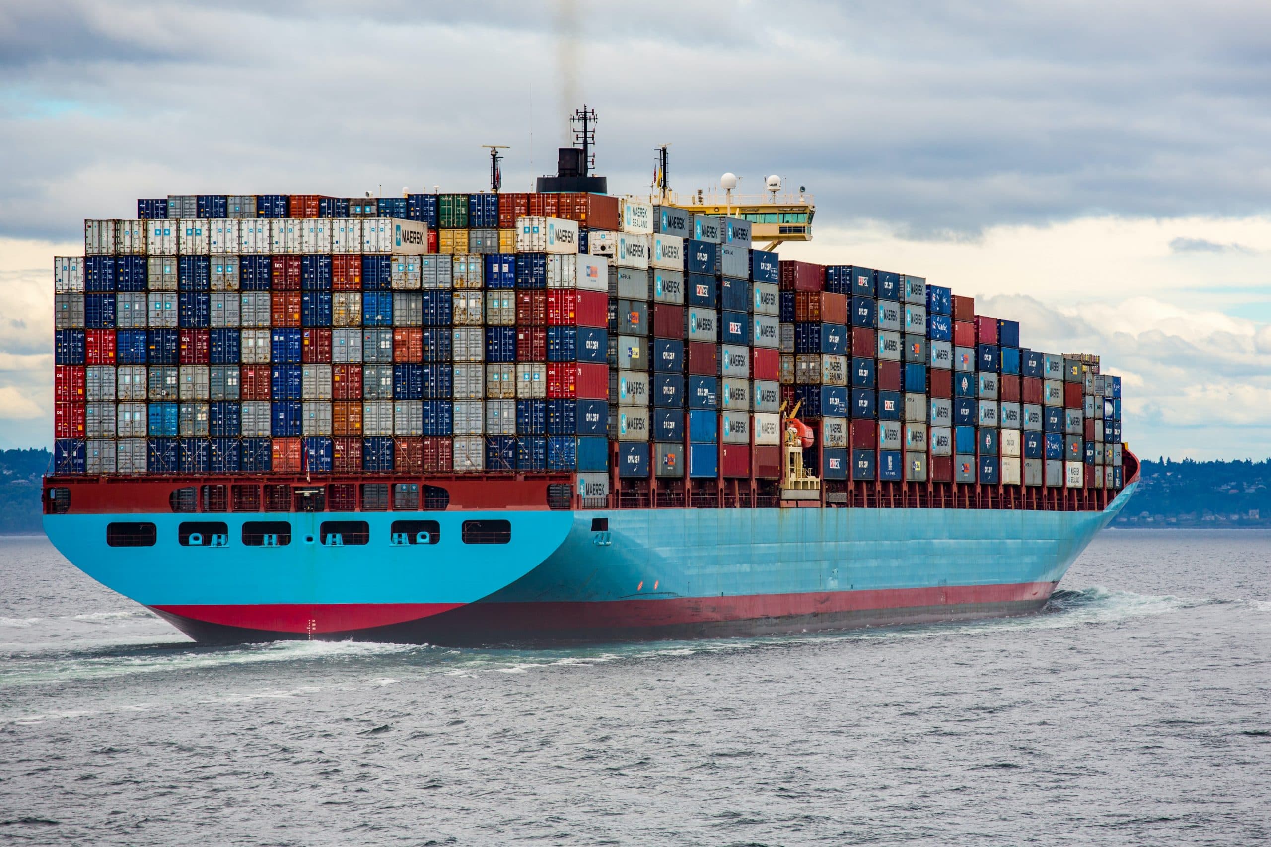 Stacked shipping containers in a busy depot