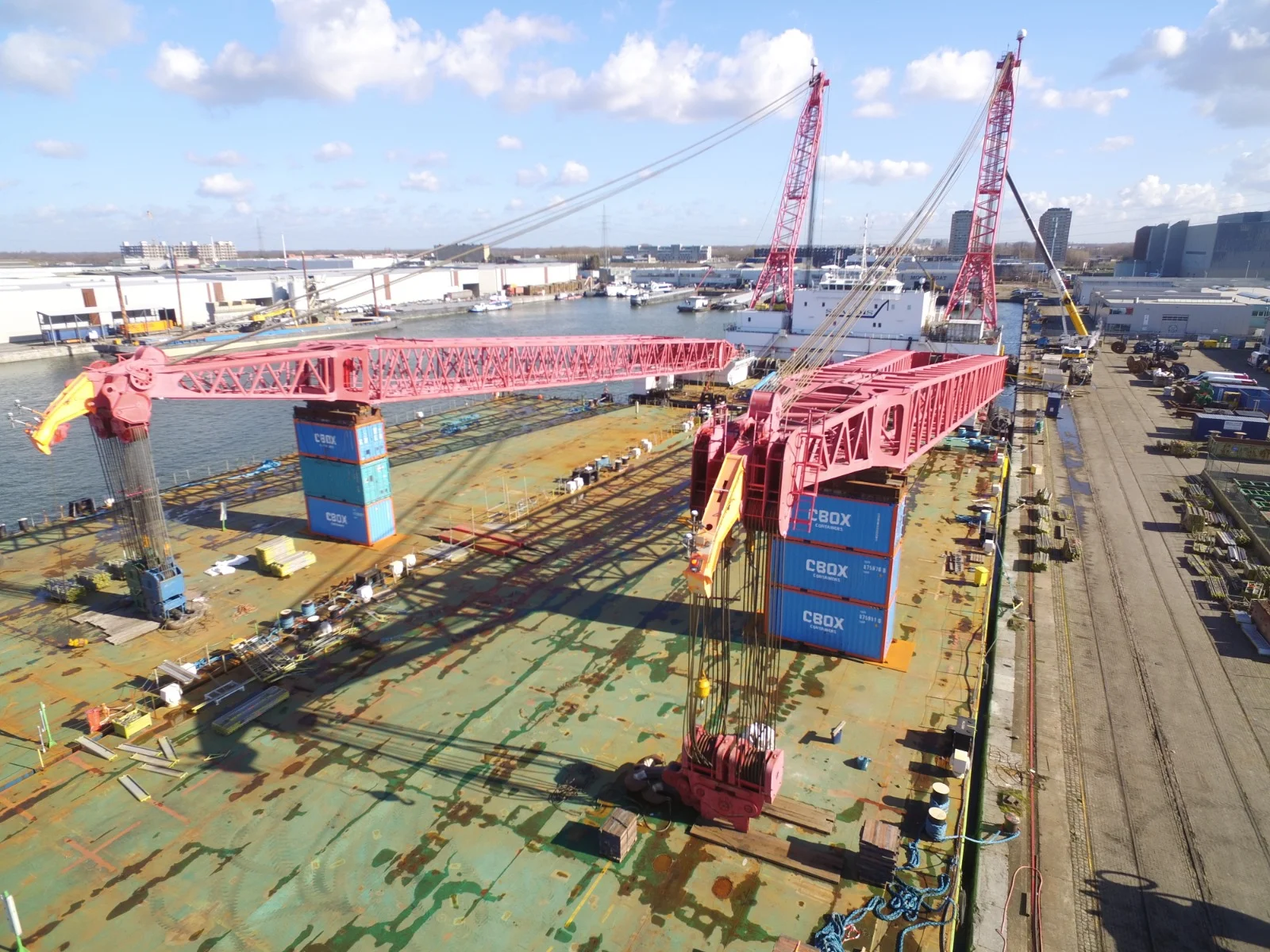 Offshore containers as a support frame for boom-extension